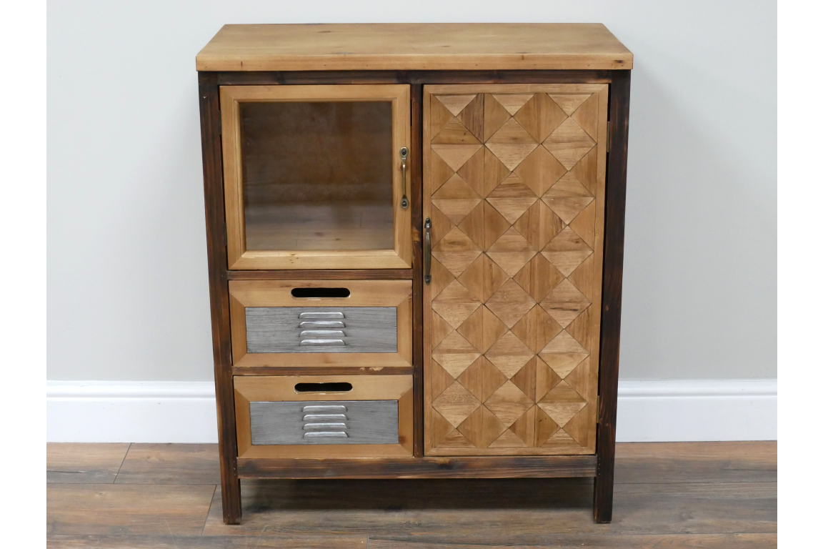 The rustic cabinet features a wooden frame with a geometric patterned door, a glass front compartment, and two metal-handled drawers for storage