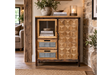 The rustic cabinet features a wooden frame with a geometric patterned door, a glass display section, and two gray drawers, perfect for stylish storage