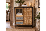 The rustic cabinet features a wooden frame with a geometric patterned door, a glass display section, and two gray drawers, perfect for stylish storage