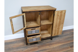 This rustic cabinet features a natural wood finish, two shelves, a glass-paneled door, and two metal-handled drawers for stylish storage and organization