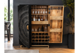 The Solstice Wine Cabinet features a striking black exterior with a textured design, showcasing wooden shelves for bottles and glassware, and a spacious wine storage section