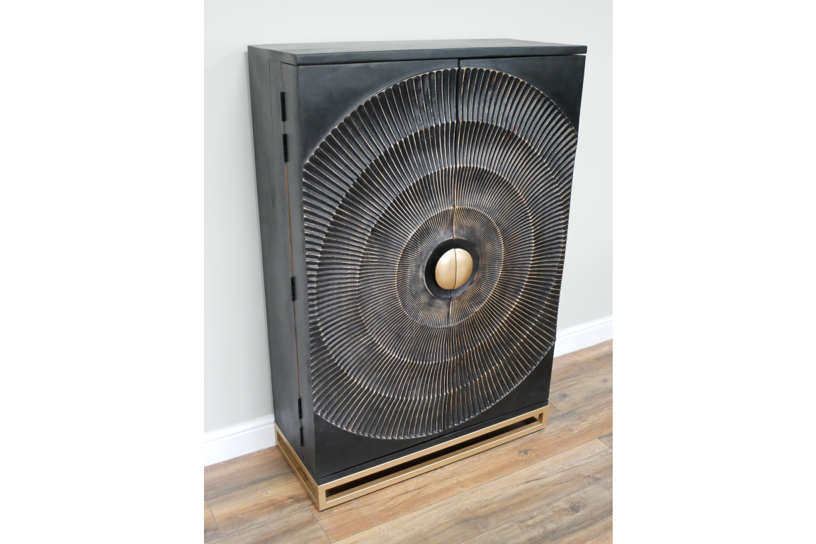 The Solstice Wine Cabinet features a sleek black finish with a textured circular design on the doors and a stylish gold base for an elegant storage solution