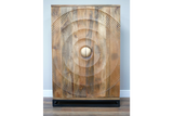 The Solstice Wine Cabinet features a natural wood finish with a striking circular textured design on the front and a round wooden knob, resting on a sleek black base