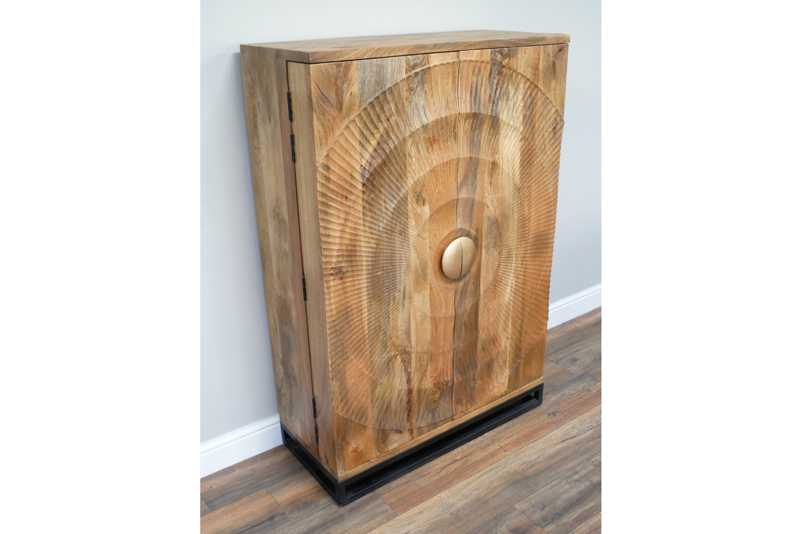 The natural wood wine cabinet features a textured circular design on the front, a round gold handle, and a sleek black base, adding a stylish touch to any space
