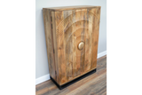 The natural wood wine cabinet features a textured circular design on the front, a round gold handle, and a sleek black base, adding a stylish touch to any space