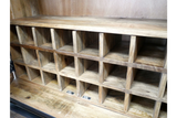 The natural wood wine cabinet features multiple compartments for storing bottles, showcasing a rustic design with a warm finish and sturdy construction