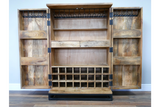 The natural wood Solstice wine cabinet features two side doors, a top shelf, a middle shelf, and a bottom wine rack with space for multiple bottles