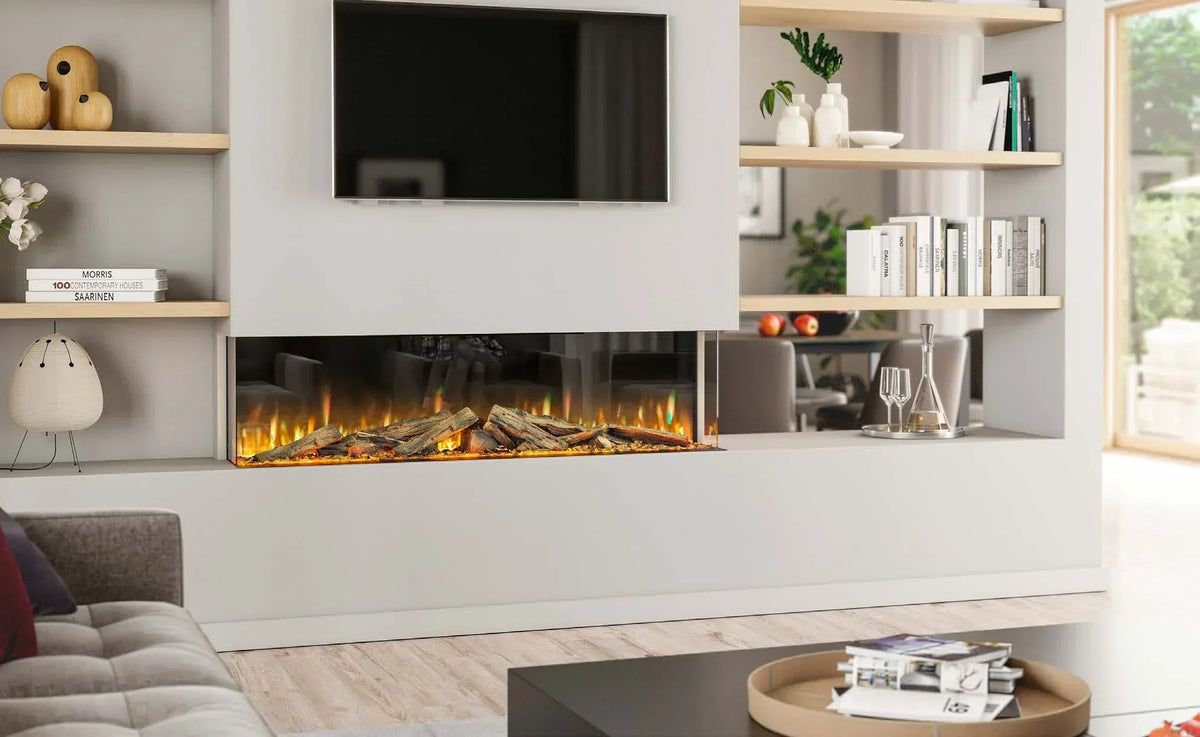 Modern electric fireplace with realistic log effect set in white wall, bookshelves, TV above