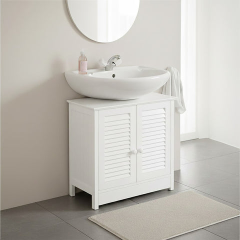 Shutter white wood under sink bathroom cabinet featuring two doors, a smooth countertop with a round sink, and a soft beige rug on the floor. The cabinet has a minimalist design and is set against a light-colored wall with a circular mirror above the sink