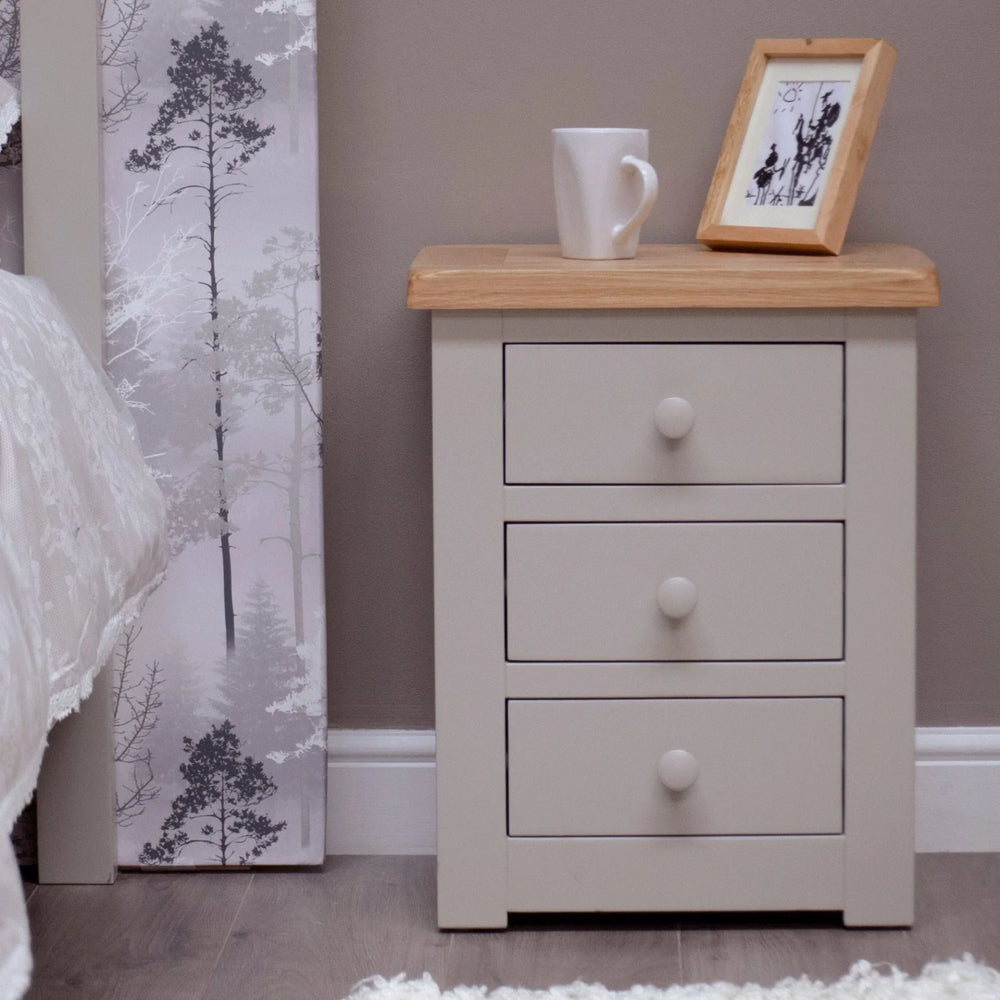 Buy bedside table online, cream nightstand with three drawers, wooden top, mug, and photo frame