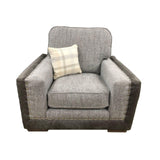 Grey fabric armchair with studded trim and check cushion front view