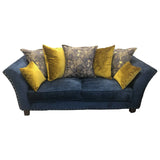 Blue fabric sofa with studded arms and mixed yellow and patterned scatter cushions