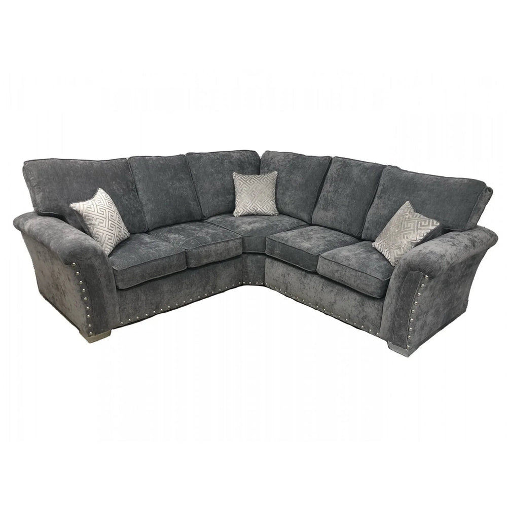 Grey corner sofa with studded arms and patterned scatter cushions