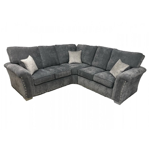 Grey corner sofa with studded arms and patterned scatter cushions