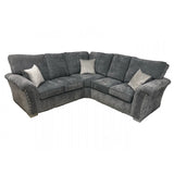 Grey corner sofa with studded arms and patterned scatter cushions