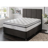Double divan bed with grey upholstered headboard and white quilted mattress in modern bedroom