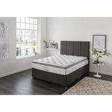 Grey fabric ottoman bed with quilted mattress in modern bedroom with large window