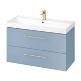 Blue bathroom vanity unit with white basin, two drawers, and gold handles