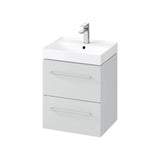 White bathroom vanity unit with two drawers and chrome handles, integrated wash basin and tap