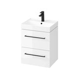 White bathroom vanity unit with two drawers and black handles, integrated sink and tap