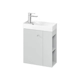 Compact bathroom vanity unit with white basin, single door, side shelves and chrome mixer tap