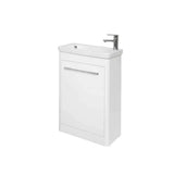White bathroom vanity unit with integrated sink and chrome tap, single door, front view