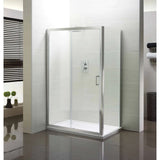 Frameless glass shower enclosure with chrome trim in a modern tiled bathroom