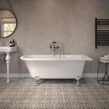 White freestanding bath with claw feet in modern bathroom with patterned floor tiles