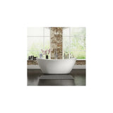 Freestanding white bathtub with chrome tap in modern bathroom with brick wall and large windows