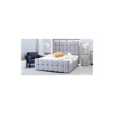 Grey upholstered bed with padded headboard in modern bedroom setting