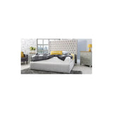 Grey upholstered bed frame with high tufted headboard in modern bedroom setting