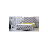 Grey upholstered bed with tufted headboard and footboard in modern bedroom setting