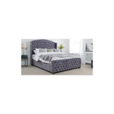 Grey velvet upholstered bed frame with deep buttoned headboard in modern bedroom