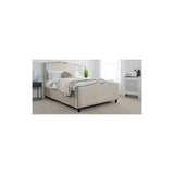 Cream upholstered bed with scalloped headboard in bright modern bedroom