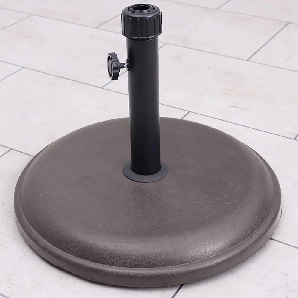 16kg brown round parasol base with polycrete finish on outdoor patio tiles