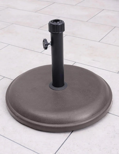 16kg brown round parasol base with polycrete finish on outdoor patio tiles