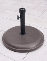 16kg brown round parasol base with polycrete finish on outdoor patio tiles
