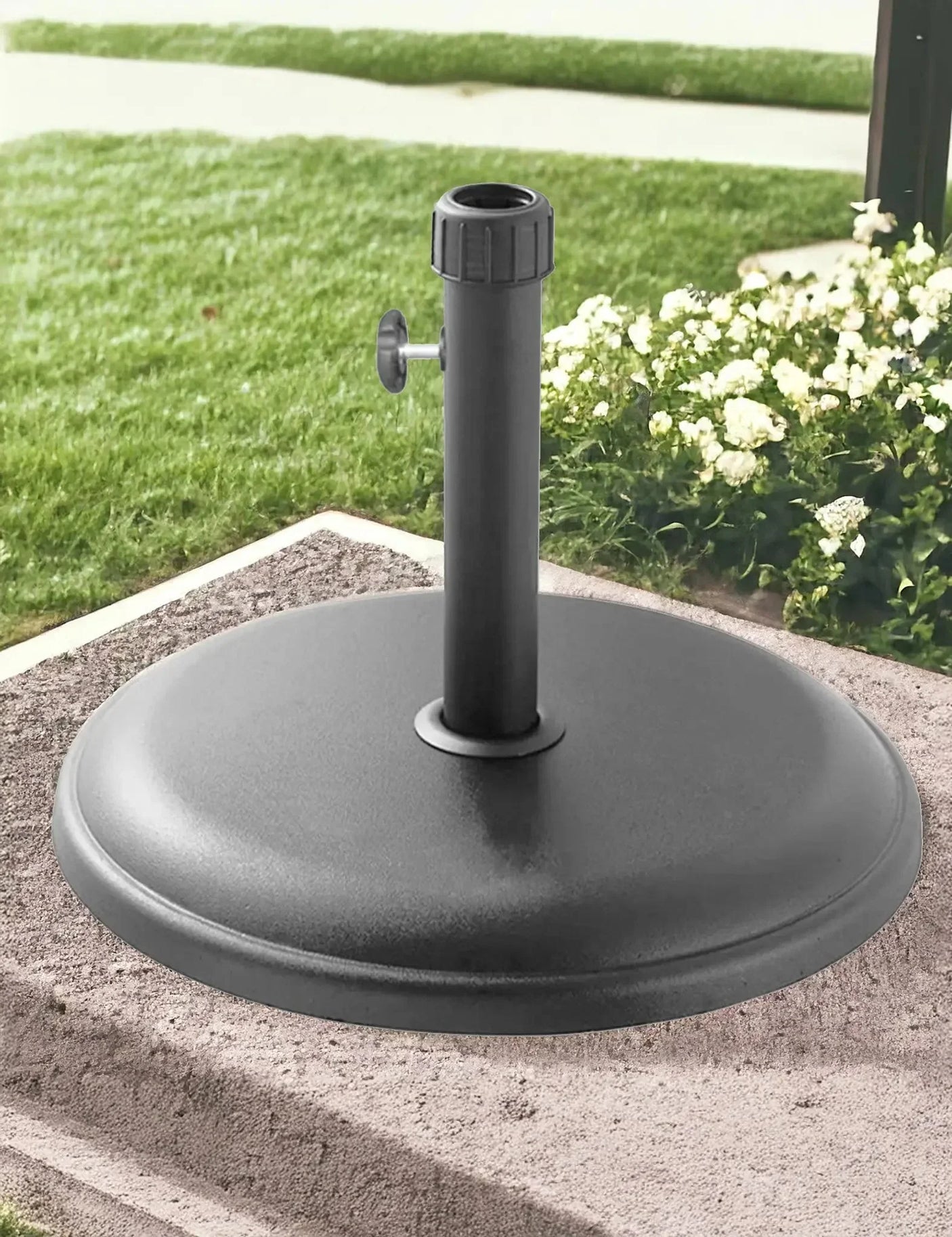 16kg light grey round parasol base polycrete on patio with garden background