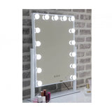LED Hollywood mirror with white frame on dressing table against brick wall