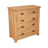 Oak chest of drawers with metal handles and five drawers on white background