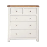 White chest of drawers with wood top and silver knobs, front view