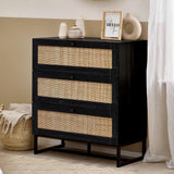 Black wood and rattan chest of drawers with decorative vases and frame on bedroom floor