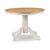 Round wooden dining table with natural oak top and white pedestal base
