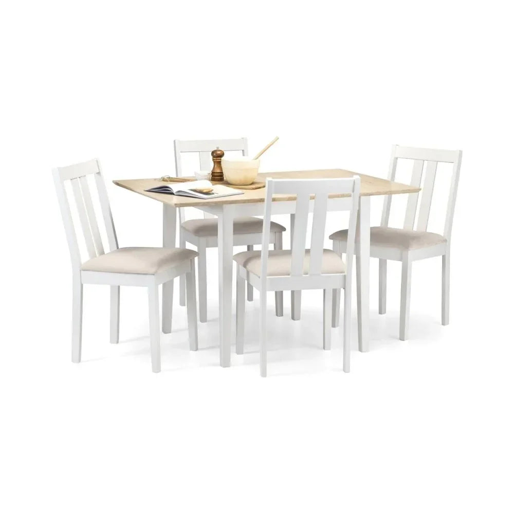 White wooden dining table set with four matching chairs and light wood tabletop