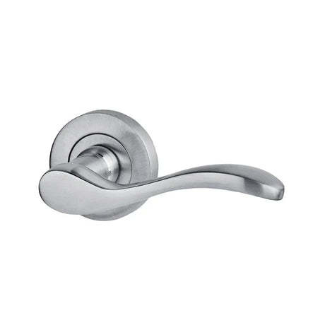 Satin chrome wave-shaped lever door handle on a round rose, close-up