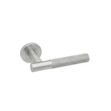 Satin-finish lever door handle with a knurled grip section, angled view