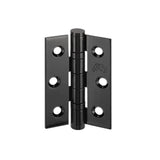 Close-up of a black metal door hinge, angled view