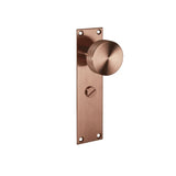 Brushed copper door knob on rectangular backplate with thumb turn lock