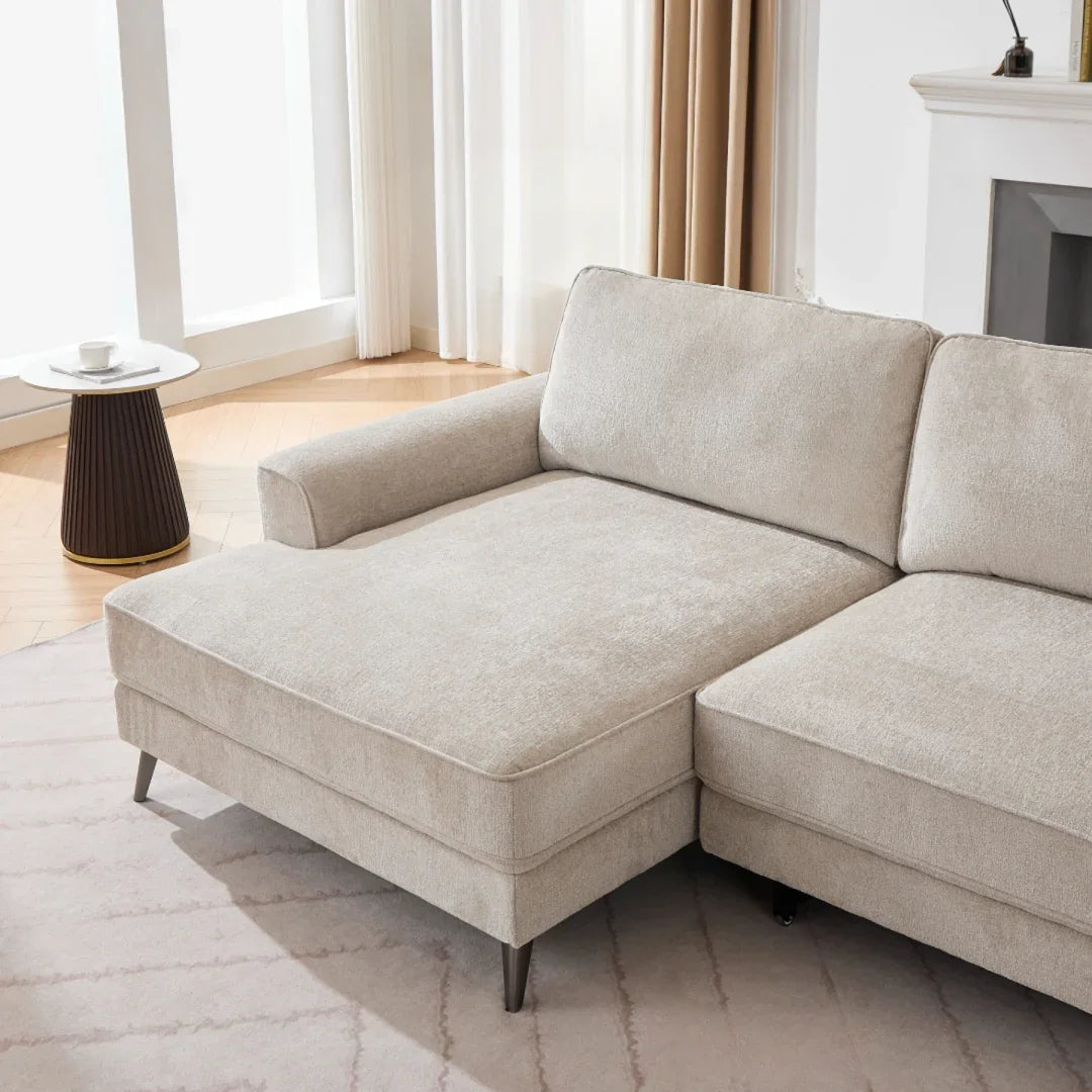 Beige fabric sectional sofa with chaise in modern living room, set on patterned area rug
