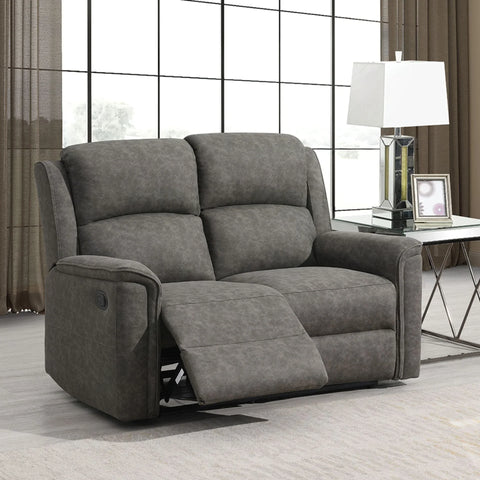 Grey fabric recliner sofa with footrest extended beside glass side table in living room